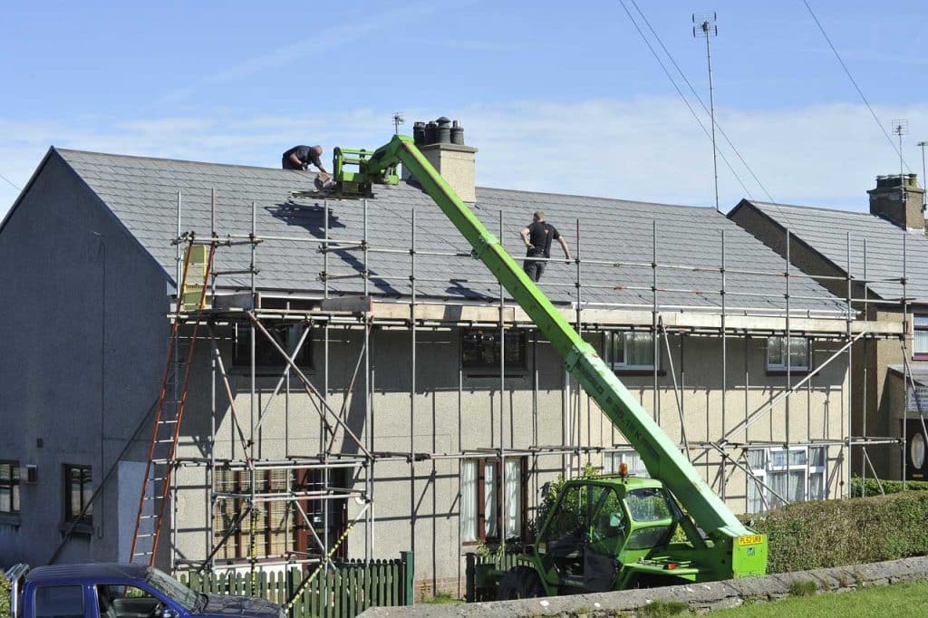 Commercial roof repair experts on roof