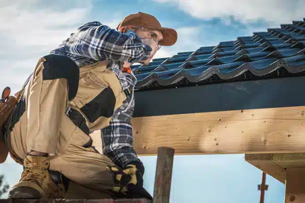 Roofer installing fascia and drip edge on a roof