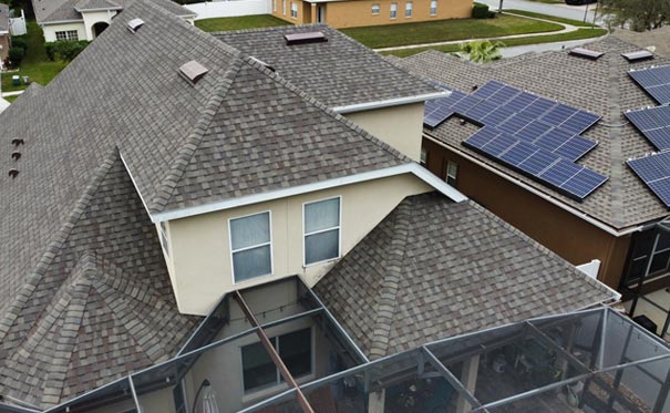 Home with a shingle roof and solar panels